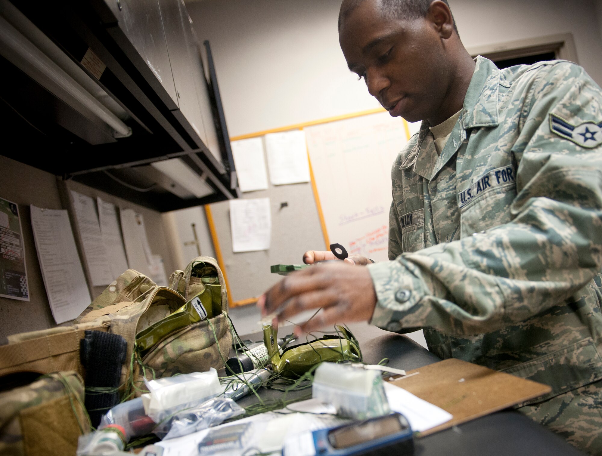 U.S. Air Force Airman 1st Class Mitchell Black, 347th Operations Support Squadron aircrew flight equipment technician, checks a compass from an aircrew survival vest at Moody Air Force Base, Ga., Dec. 6, 2012. The survival vest contains items like flares, maps, a compass, water purification tablets and other items to help aircrew members survive and signal rescue personnel. (U.S. Air Force photo by Airman 1st Class Jarrod Grammel/Released)
