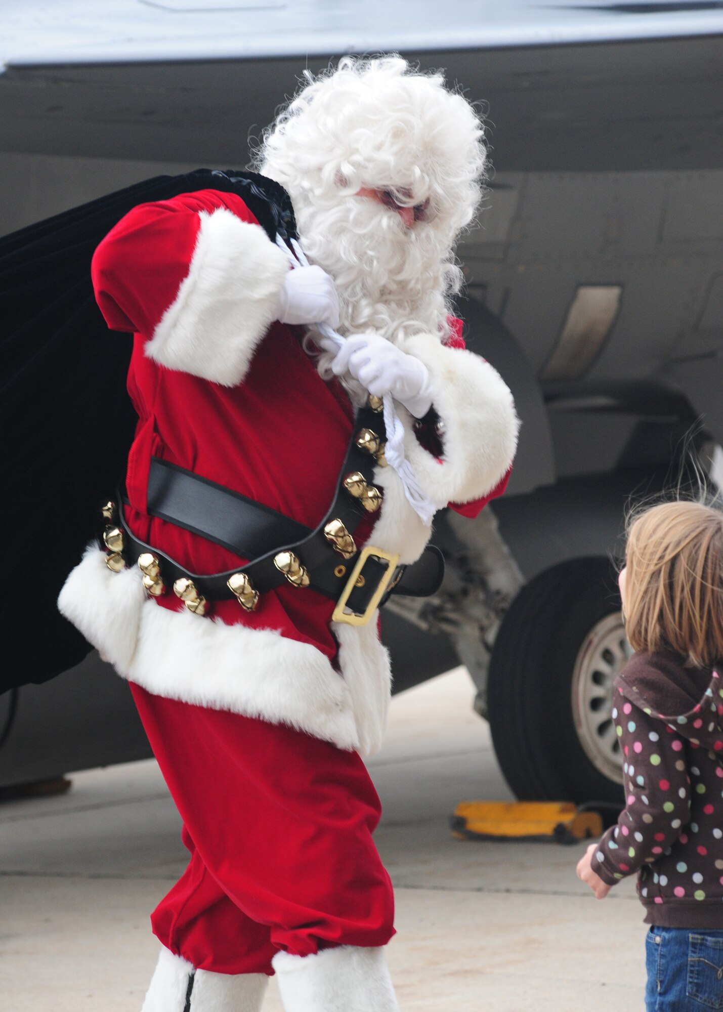 Santa is greeted by a child after he gets out of an F-16 Fighting Falcon fighter jet at Hill Air Force Base, Utah, for the annual 388th Fighter Wing holiday party Dec. 8. (U.S. Air Force photo by Kim Cook/Released). 
