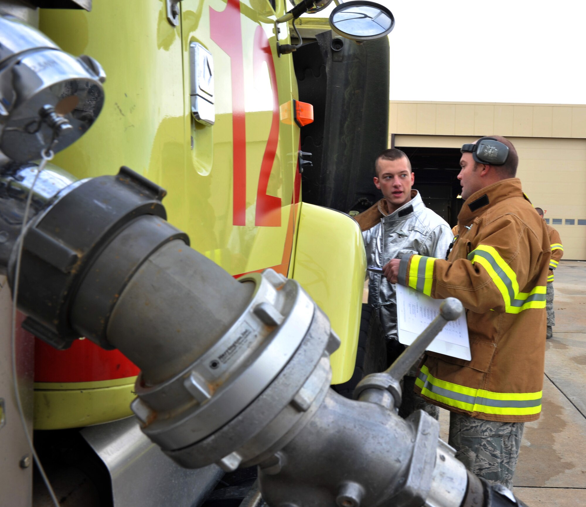 Airman 1st Class Kyle Lawall and Staff Sgt. James Barding, Team Whiteman firefighters, perform a vehicle inspection Dec. 5 at Whiteman Air Force Base, Mo. Whiteman AFB Fire Emergency Services works all day, every day to protect Team Whiteman and provide assistance in the surrounding communities. (U.S. Air Force photo/Heidi Hunt) (Released)