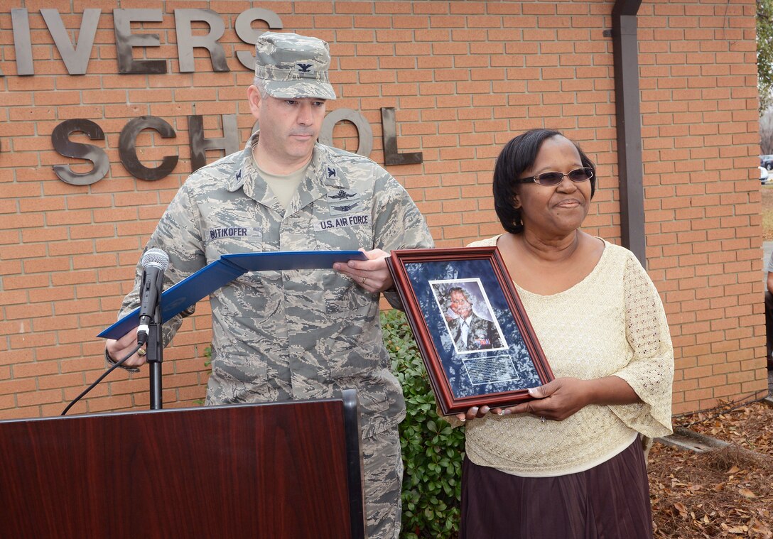 The Robins Airman Leadership School was dedicated Tuesday in honor of Staff Sgt. Felicia Rivers. Installation Commander Col. Mitchel Butikofer gives Rivers’ mother, Paula Campbell, one of a number of presentations in honor of her daughter.(U. S. Air Force photo/Raymond Crayton)