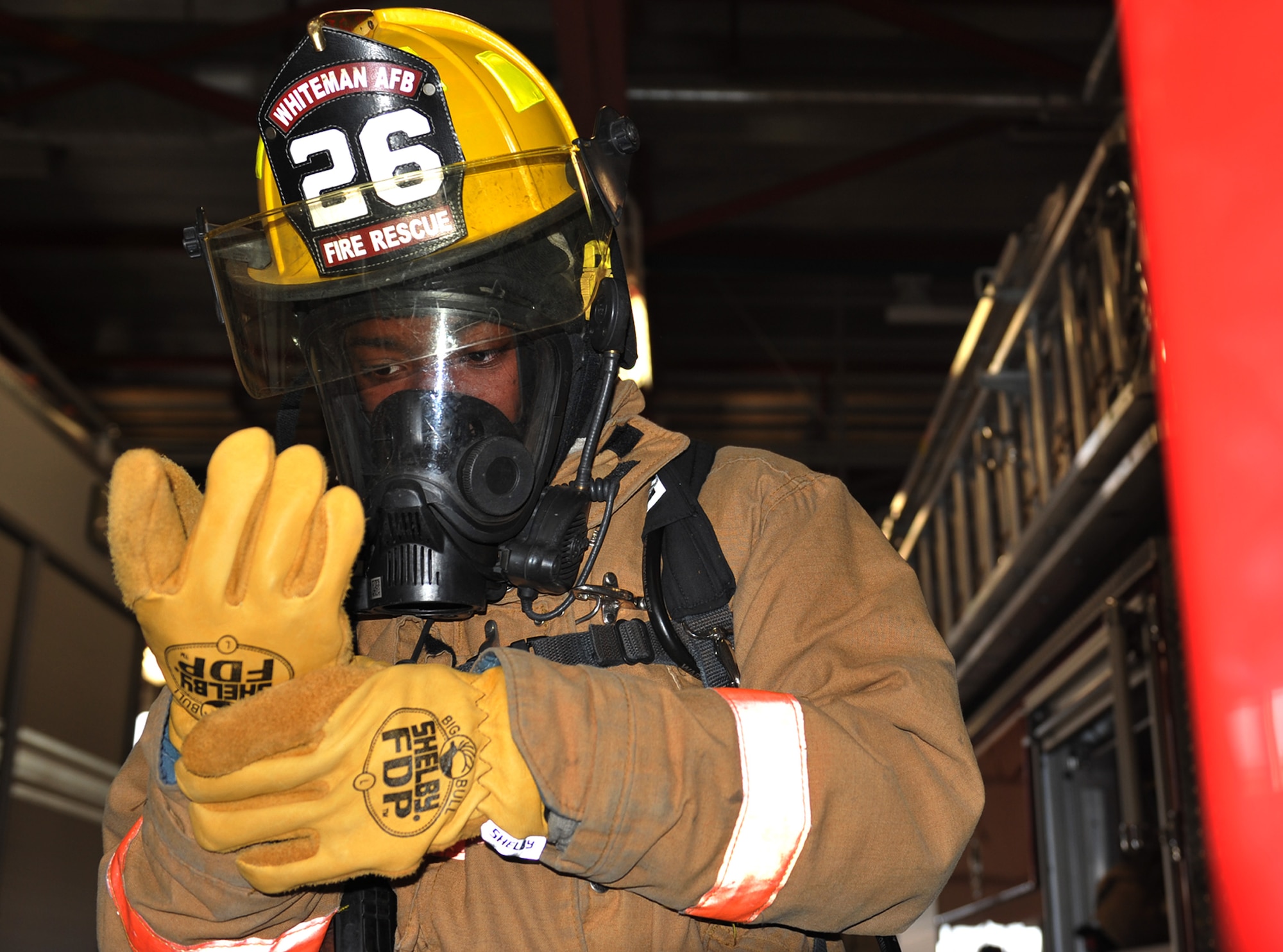 Airman 1st Class Cory Barrett, Team Whiteman firefighter, suits up during a bunker exercise drill Dec. 7 at Whiteman Air Force Base, Mo. Airmen from Whiteman AFB Fire Emergency Services works in two separate shifts to keep the station manned and mission ready 24/7, 365 days a year. (U.S. Air Force photo/Heidi Hunt) (Released)