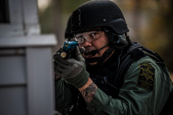 A Charleston County Sheriff’s Office Special Weapons and Tactics member aims his training weapons containing simulated rounds at a house during a hostage extraction training exercise Dec. 6, 2012, at vacant housing on Joint Base Charleston – Air Base, S.C. The SWAT team provides a coordinated response to critical incidents throughout Charleston County, and whenever requested, in other areas throughout the state of South Carolina. (U.S. Air Force photo/ Senior Airman Dennis Sloan)