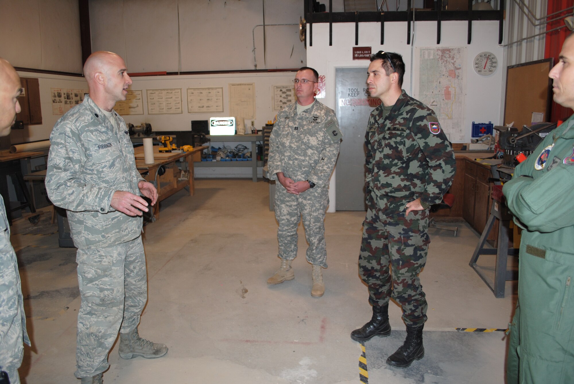 Lt. Col. John Stevenson, 140th Operation Support Squadron Airburst Range commander (left center) Stevens, Capt. Perry Read (center) and Slovenian armed Forces Sgt. 1st Class Darko Roth (right center) discuss training range management and how the Colorado Airmen manufacture their own training assets, such as targets, during a State Partnership Program visit to the 140th Operations Squadron's Airburst Range at Fort Carson, Colo., Oct. 31, 2012. The CONG and the Republic of Slovenia have been partner nations since 1993, when the program began. In addition to many other milestones in the program, Citizen-Soldiers from the CONG and soldiers from Slovenia have deployed together many times as members of the Operational Mentor Liaison Teams, now called Military Assistance Teams, to help train soldiers of the Afghan National Army. (Official Army National Guard photo by Officer Candidate Jennings Catlett)