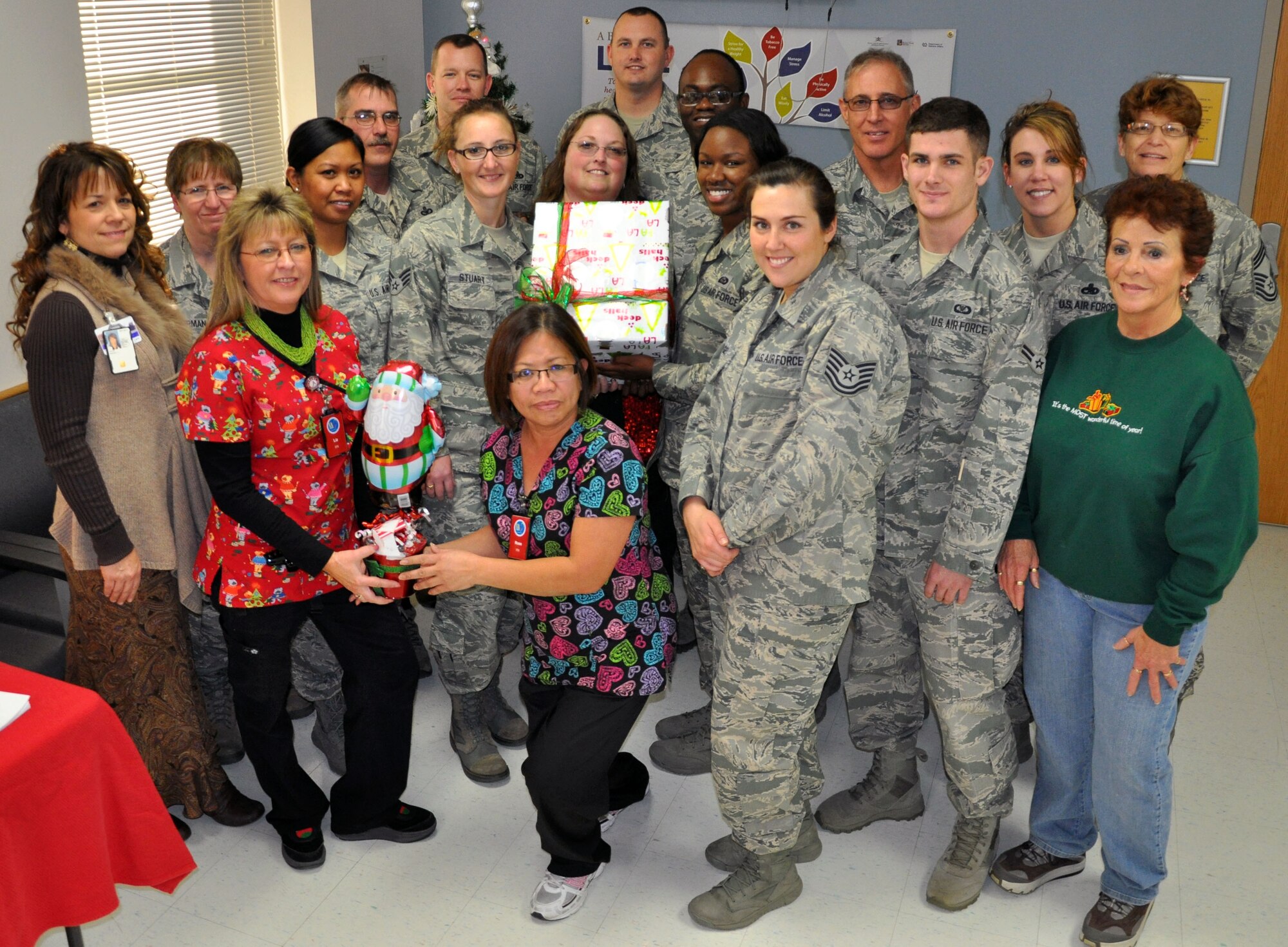Members of the 931st Air Refueling Group, McConnell Air Force Base, Kan., pose with staff members from the Robert J. Dole Veterans Medical Center in Wichita, Kan., Dec. 12, 2012.  The staff at the medical center held a holiday open house celebration, during which they collected donations for McConnell Airmen and their families who are in need during the holiday season.  (U.S. Air Force photo by 1st Lt. Zach Anderson)