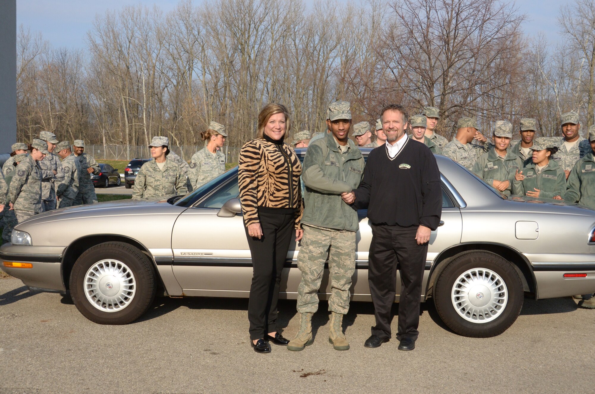 WRIGHT-PATTERSON AIR FORCE BASE, Ohio - Airman 1st Class Stephan Hall, 445th Force Support Squadron services journeyman, receives a car Dec. 1 donated by Dave and Jan Murphy, owners of Murphy’s Autocare of Beavercreek, Ohio, as part of the Charity Cars Program. The Murphy’s along with other organizations are participants in the Charity Cars Program that donates vehicles to those in need. (U.S. Air Force photo/Staff Sgt. Mikhail Berlin)
