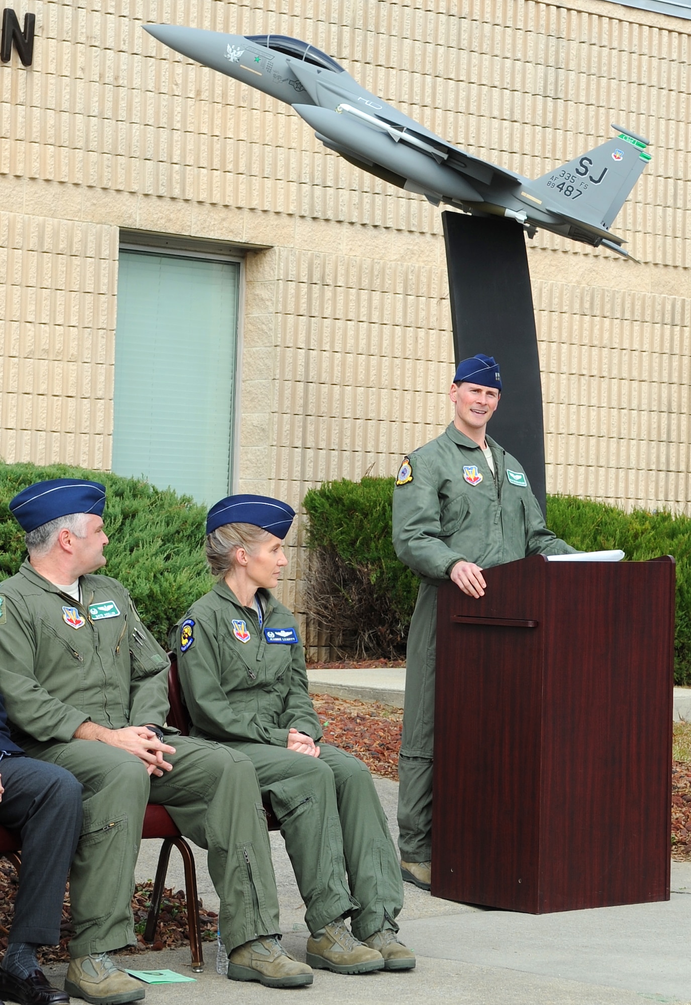 U.S. Air Force Capt. Ryan Bodenheimer, 335th Fighter Squadron pilot, performs a dedication during the 10,000 flying hour presentation for 335th FS flag ship F-15E Strike Eagle 487. Representatives from Boeing and Atlantic models presented a scale model of 487 to commemorate the achievement. (U.S. Air Force photo/Airman 1st Class Gino Reyes/Released)