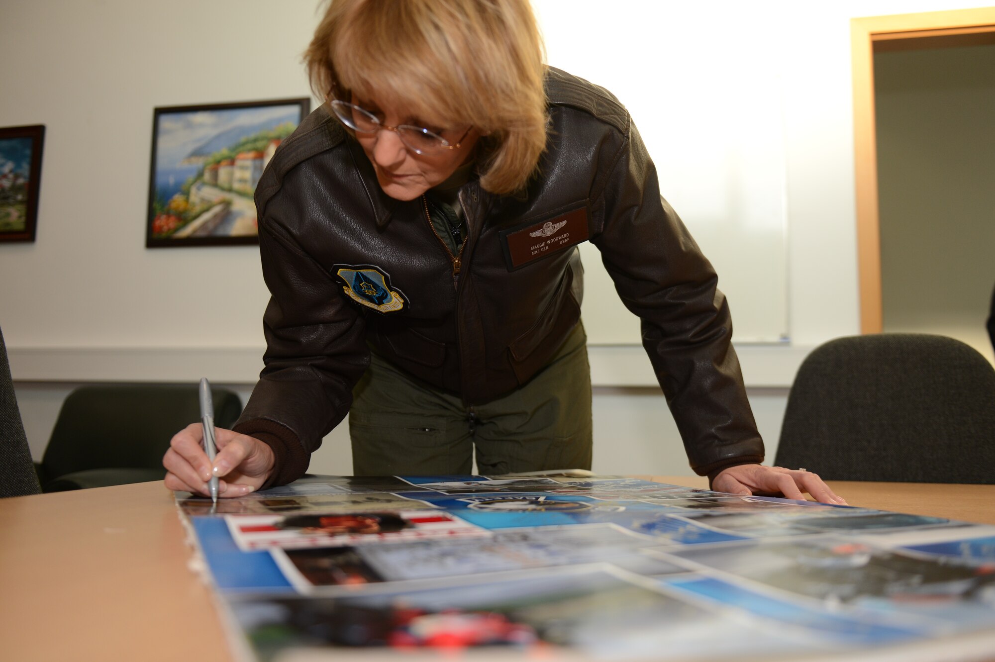 SPANGDAHLEM AIR BASE, Germany – U.S. Air Force Maj. Gen. Margaret Woodward, Air Force Chief of Safety, signs a safety poster inside the 52nd Fighter Wing Safety office Dec. 12, 2012. Woodward visited Spangdahlem to experience firsthand the safety office’s vision, values and mission. (U.S. Air Force photo by Airman 1st Class Gustavo Castillo/Released)