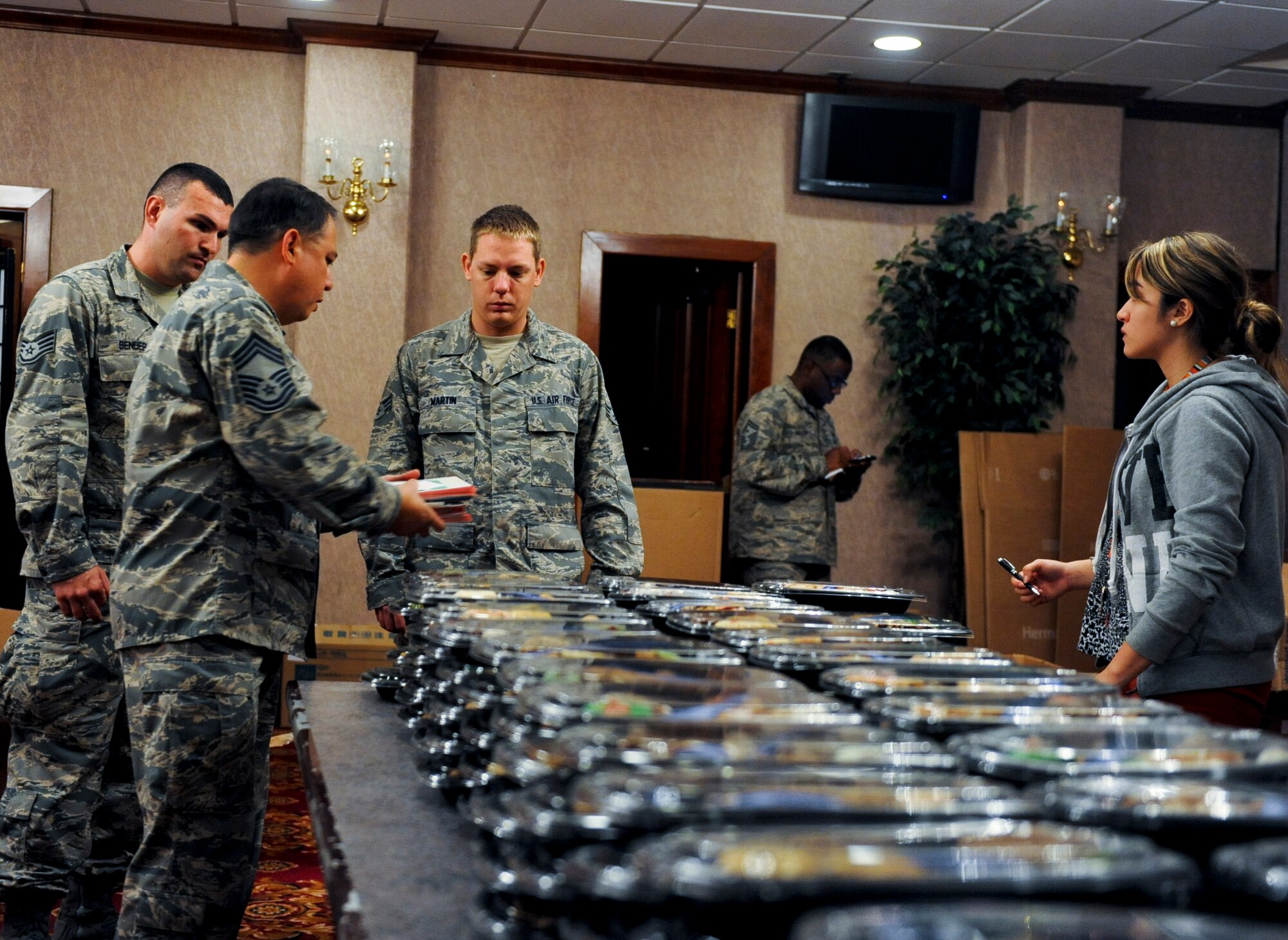Volunteers from the 18th Medical Group prepare to load cookie trays into boxes on Kadena Air Base, Japan, Dec. 11, 2012. More than 2,700 cookie trays were made for single service members, to provide them with a little taste of home while they are away from their families during the holiday season. (U.S. Air Force photo/Airman 1st Class Justin Veazie)