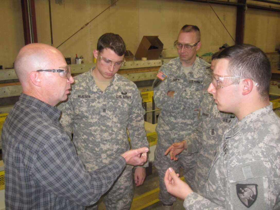Members of the ERDC/West Point SIP-Hut team discuss material requirements for experimental and objective line research.