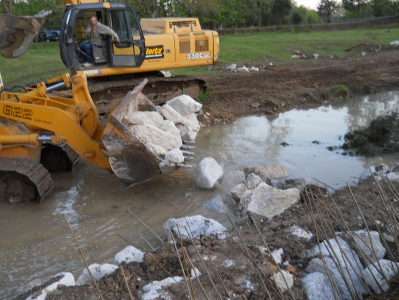 Large crushed rock is strategically placed to stabilize stream banks.