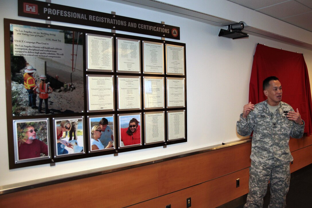 District Commander Col. Mark Toy unveiled two display boards Dec. 13 in the 12th floor conference room here. One for professional registrations and certifications and one for individual and organizational awards and recognition.