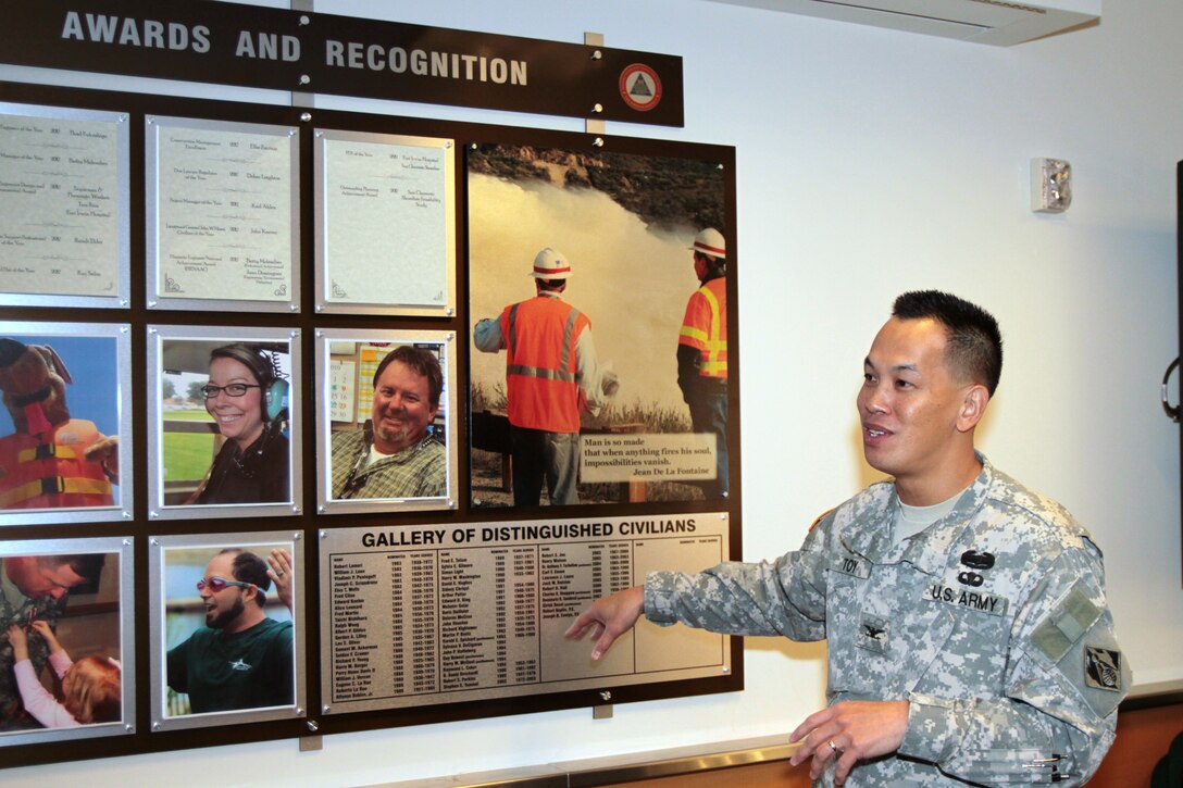District Commander Col. Mark Toy unveiled two display boards Dec. 13 in the 12th floor conference room here. One for professional registrations and certifications and one for individual and organizational awards and recognition.