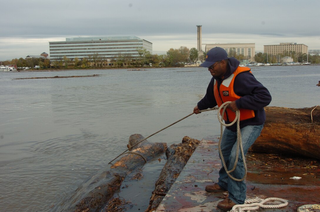 A Baltimore District employee removes downed trees from a Chesapeake Bay waterway. 