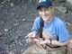 Visitor to a recreation site shows her recent fishing catch.