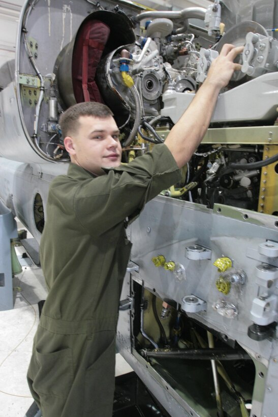 Lance Cpl. Thomas A. Fowler, a flight line mechanic with Marine Light Attack Helicopter Squadron 467, works on an AH-1 Super Cobra in the HMLA-467 hangar on Dec. 5. Fowler was one of about 10 Marines from the squadron who went to New York in support of Hurricane Sandy recovery operations.