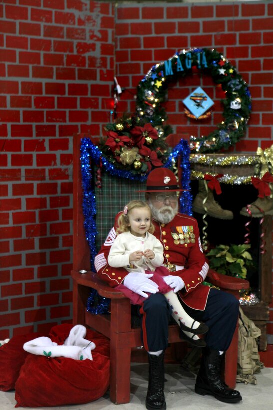 Hanna, the daughter of an aircraft mechanic with Marine Aviation Logistics Squadron 14, tells Gunny Claus what she wants for Christmas Dec. 6 at the Marine Aircraft Group 14 Winter Wonderland in the Marine Attack Squadron 231 hangar. The event featured games, crafts and pizza for families to enjoy.