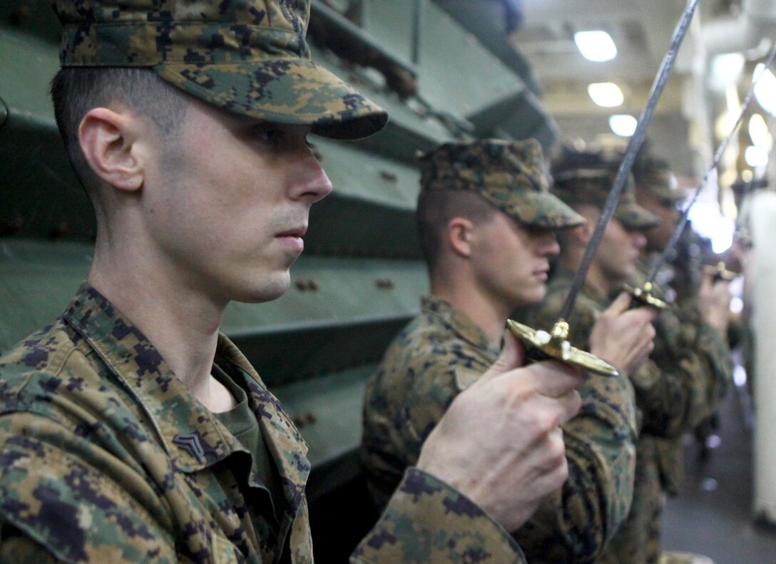 Cpl. Christopher Bennett, left, a native of Monroe, Conn., and Marine Air-Ground Task Force planner with the 24th Marine Expeditionary Unit, practices sword manual during Corporals Course Class 014-13 aboard the USS New York, Dec. 4, 2012. The 24th Marine Expeditionary Unit is deployed with the Iwo Jima Amphibious Ready Group in the 6th Fleet area of responsibility serving as an expeditionary crisis response force capable of a variety of missions from full-scale combat to evacuations and humanitarian assistance.