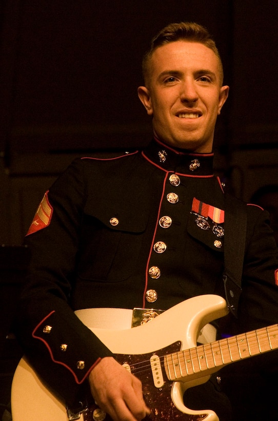 Cpl. Mark Broughton, a musician with the 2nd MAW Band, plays guitar at the annual Christmas concert Dec. 7 at Marine Corps Air Station Cherry Point, N.C. The event open to the public, and the community was encouraged to bring donations for Toys for Tots.


