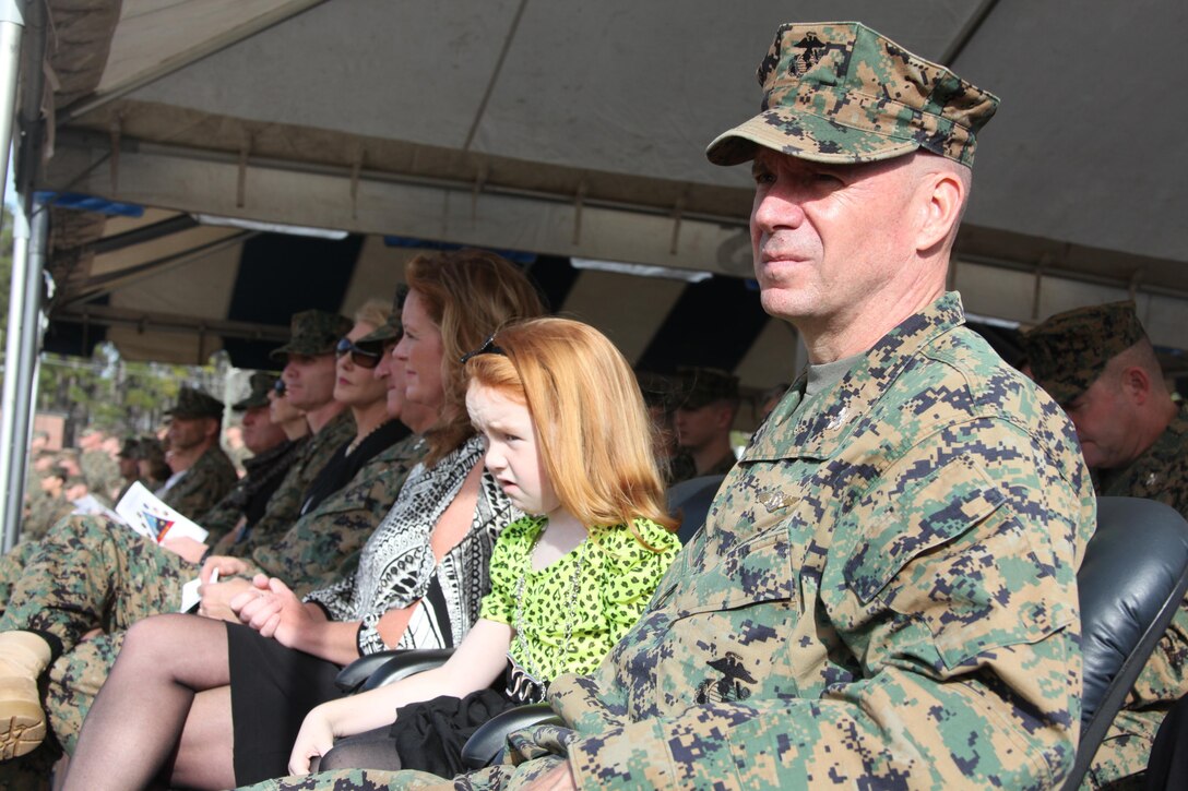 Col. Peter J. DeVine, the outgoing commanding officer of Marine Air Control Group 28, and his family watch the 2nd Marine Aircraft Wing Band perform at the MACG-28 change of command at the Marine Air Control Squadron 2’s parade field Dec. 5. Following 34 years of honorable service to his country and Corps, DeVine is retiring following relinquishing his command of the group. DeVine thanked his Marines for their work during his tenure.