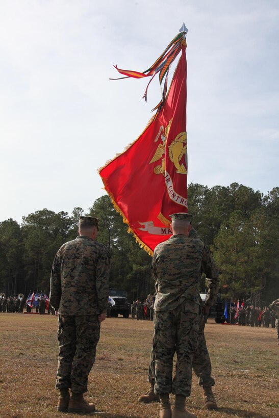 Col. Peter J. DeVine, right, the outgoing commanding officer of Marine Air Control Group 28, takes the group colors from Sgt. Maj. Timothy King, the sergeant major of MACG-28, at the MACG-28 change of command at the Marine Air Control Squadron 2’s parade field Dec. 5. The passing of the colors is a symbolic exchange of command of the unit.