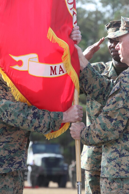 Col. Peter J. DeVine, right, the outgoing commanding officer of Marine Air Control Group 28, hands the unit colors to Col. Jeff S. Kojac, the incoming commanding officer, during the exchanging of the unit colors at the MACG-28 change of command at the Marine Air Control Squadron 2’s parade field Dec. 5. The passing of the colors is a symbolic exchange of command of the unit.