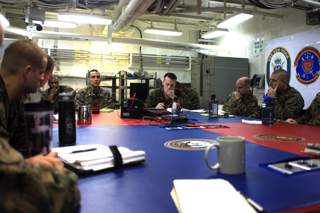 Lt. Col. David Sosa, the commanding officer of Battalion Landing Team 1st Battalion, 2nd Marine Regiment, 24th Marine Expeditionary Unit, discusses upcoming post-deployment concerns with 24th MEU leadership aboard the USS New York, Dec. 8, 2012. The 24th MEU is returning home in time for the holidays after spending most of 2012 deployed in the U.S. Navy's 5th and 6th Fleet areas of responsibility as an expeditionary crisis response force, maintaining presence aboard the ships of the Iwo Jima Amphibious Ready Group within the U.S. Central, European and Africa Commands. (U.S. Marine Corps photo by 2nd Lt. Joshua W. Larson)