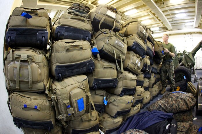 Pfc. Stephen Frame, a native of Ft. Walton Beach, Fla., a cannon crewman with India Battery, Battalion Landing Team 1st Battalion, 2nd Marine Regiment, 24th Marine Expeditionary Unit, stacks baggage aboard the USS New York, Dec. 13, 2012, in preparation for the MEU's offload. The 24th MEU is returning home in time for the holidays after spending most of 2012 deployed in the U.S. Navy's 5th and 6th Fleet areas of responsibility as an expeditionary crisis response force, maintaining presence aboard the ships of the Iwo Jima Amphibious Ready Group within the U.S. Central, European and Africa Commands. (U.S. Marine Corps photo by Cpl. Michael Petersheim)