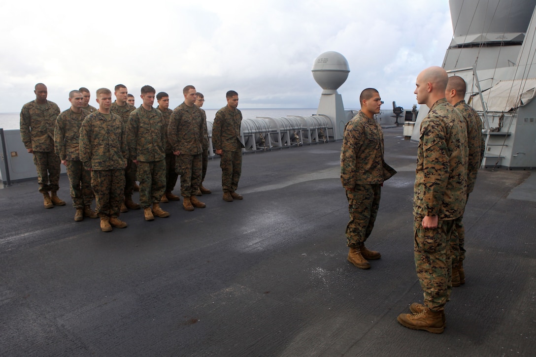 Cpl. Luis G. Rivera, center, a native of Brownsville, Texas, and radio operator with the 24th Marine Expeditionary Unit, receives a Certificate of Commendation aboard the USS New York, Dec. 9, 2012. The 24th Marine Expeditionary Unit is coming home from a nine-month deployment with the Iwo Jima Amphibious Ready Group in which they served as an expeditionary crisis response force in the 5th and 6th Fleet areas of responsibility. (Official USMC Photo by: Cpl. Michael J. Petersheim/Released)