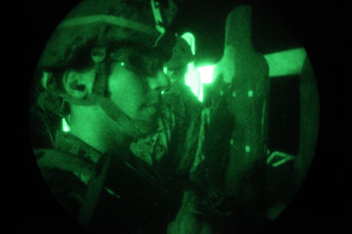 USS IWO JIMA, Atlantic Ocean (Dec. 9, 2012) - Lance Cpl. David Calle, a Miami, Fla., native with Security Platoon, Headquarters and Service Company, Battalion Landing Team 1st Battalion, 2nd Marine Regiment, 24th Marine Expeditionary Unit, checks his shot group after conducting a live-fire night training exercise aboard USS Iwo Jima, Dec. 9, 2012. The 24th MEU is deployed with the Iwo Jima Amphibious Ready Group and is currently in the 6th Fleet area of responsibility. Since deploying in March, they have supported a variety of missions in the U.S. Central, Africa and European Commands, assisted the Navy in safeguarding sea lanes, and conducted various bilateral and unilateral training events in several countries in the Middle East and Africa. (U.S. Marine Corps photo by Lance Cpl. Tucker S. Wolf/Released)