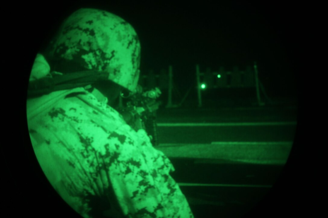 Lance Cpl. David Calle, a Miami, Fla., native with Security Platoon, Headquarters and Service Company, Battalion Landing Team 1st Battalion, 2nd Marine Regiment, 24th Marine Expeditionary Unit, conducts a live-fire night training exercise aboard USS Iwo Jima, Dec. 9, 2012. The 24th MEU is deployed with the Iwo Jima Amphibious Ready Group and is currently in the 6th Fleet area of responsibility. Since deploying in March, they have supported a variety of missions in the U.S. Central, Africa and European Commands, assisted the Navy in safeguarding sea lanes, and conducted various bilateral and unilateral training events in several countries in the Middle East and Africa. (U.S. Marine Corps photo by Lance Cpl. Tucker S. Wolf/Released)