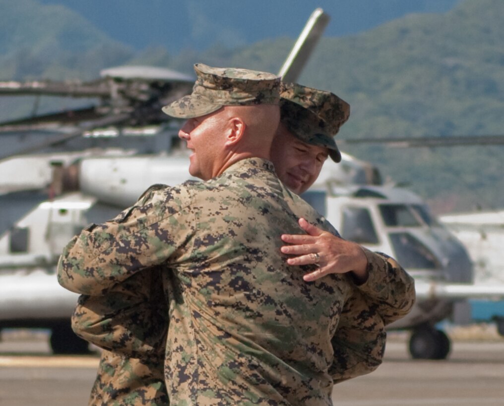 MARINE CORPS BASE HAWAII - Lt. Col. Christopher H. Oliver, commanding officer and Sgt. Maj. Timothy C. Tackett, sergeant major, Marine Heavy Helicopter Squadron 362, embrace after retiring the colors at a deactivation ceremony for the squadron, Nov. 30, 2012. (Official U.S. Marine Corps photo by Kristen Wong)