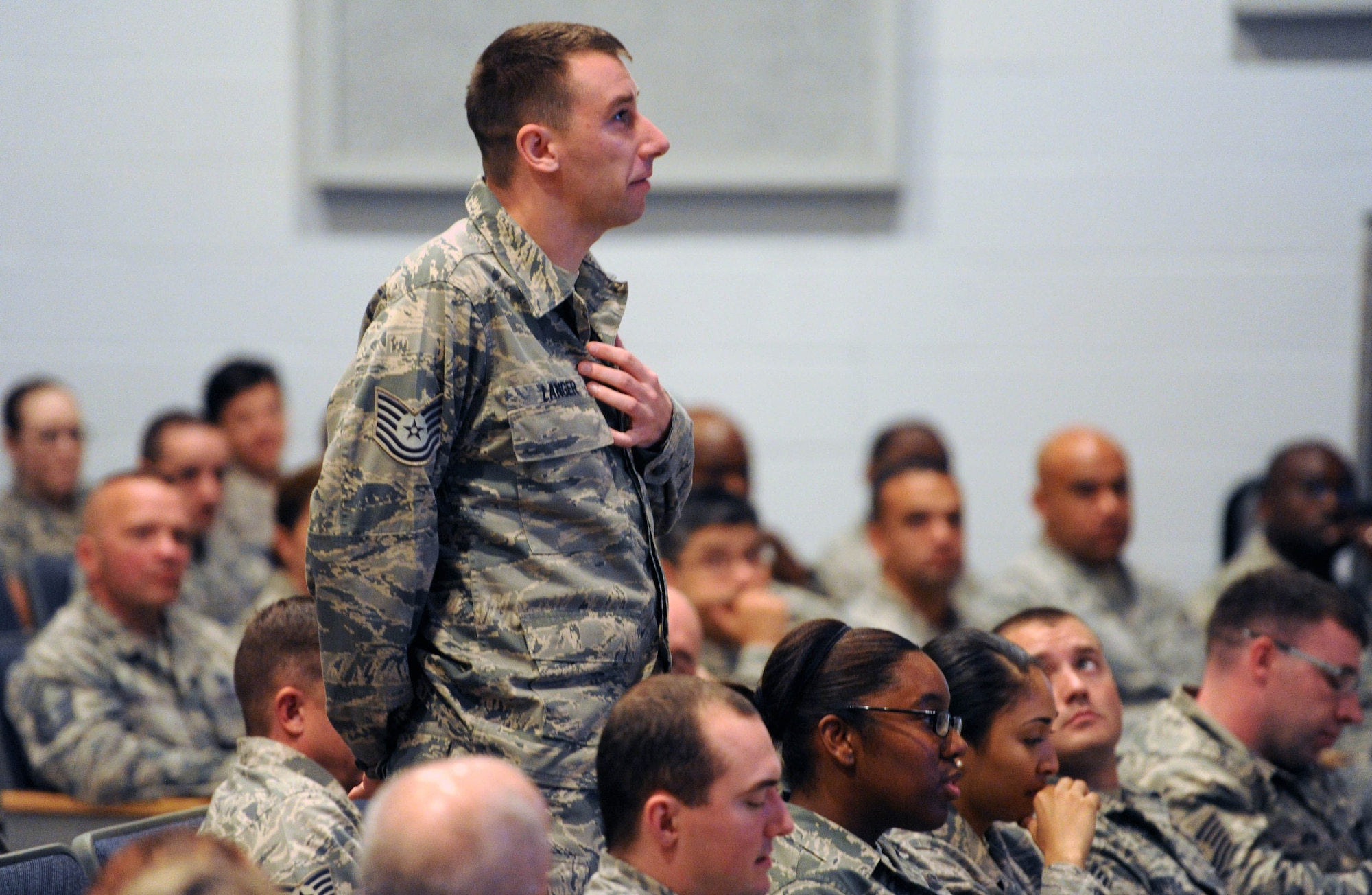 Tech Sgt. Michael Langer, 747th Communications Squadron, asks a question to Chief Master Sgt. Les Bramlett, 15th Wing command chief, during an enlisted call at the base theater Dec. 13 at Joint Base Pearl Harbor-Hickam, Hawaii. During the call, Bramlett discussed various topics including the five 15th WG priorities: execute the mission, ensure readiness, develop our Airmen, grow resilient Airmen and families, and strengthen partnerships. (U.S. Air Force photo by Staff Sgt. Nathan Allen)
