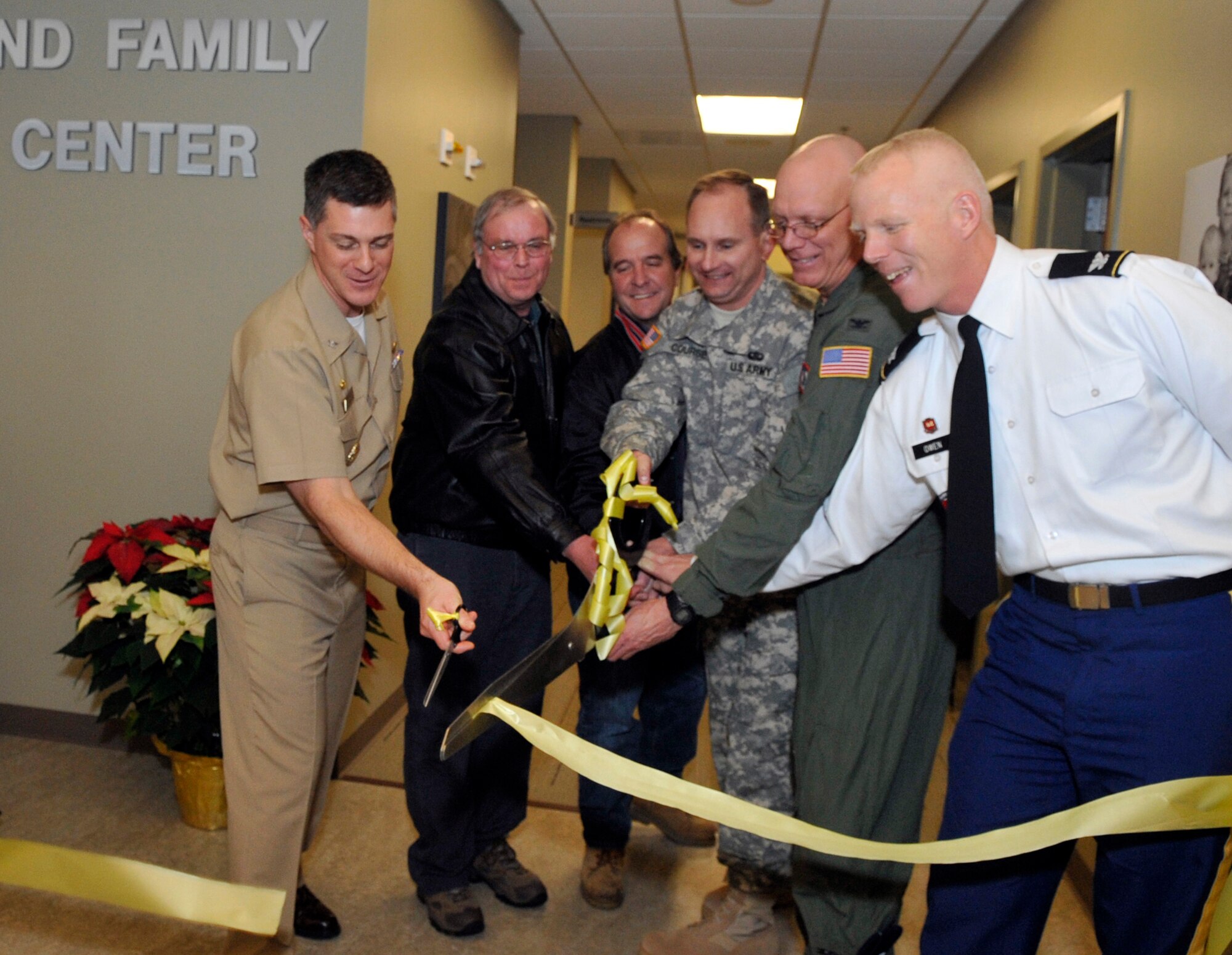 Navy Capt William Bulis, Joint Base McGuire-Dix-Lakehurst deputy commander, John Wilson, Green Jacket Contractors LLC, Stan Lyman, 87th Civil Engineer Squadron, Army Col. Charles Coursey, JB MDL deputy commander, Col Michael Underkofler, 514th Air Mobility Wing commander, and Army Col. Paul Owen, New York District of the U.S. Army Corps of Engineers commander, cut the ceremonial ribbon during the Grand Opening of the new Military and Family Support Center Dec. 7, 2012 at JB MDL, N.J. The new $7.6 million facility merges the Airman and Family Readiness Center, Navy Fleet and Family Support Center and Army Community into one to support all service members. (U.S. Air Force photo by Wayne Russell/Released)