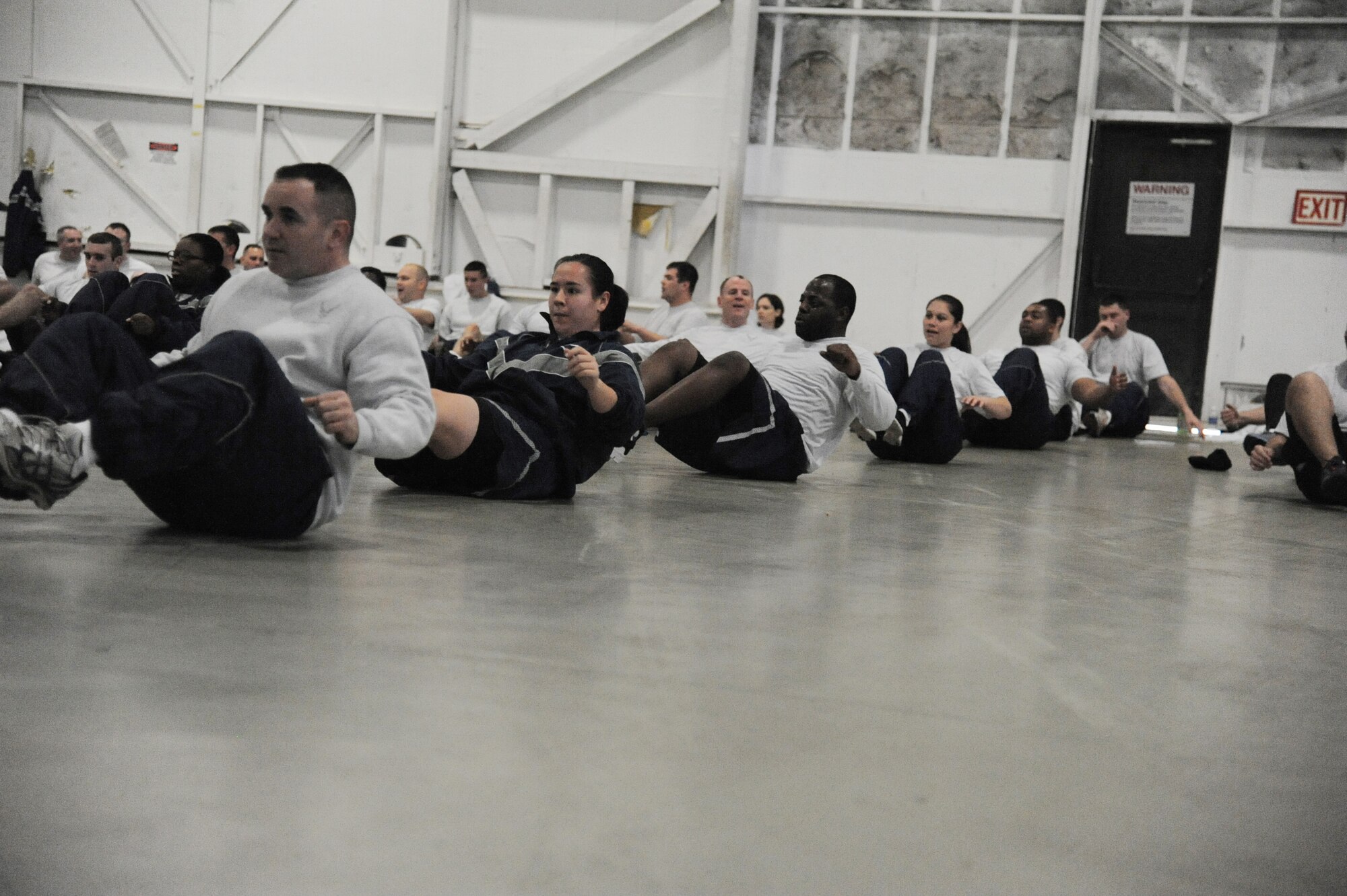 Airmen from the 621st Contingency Response Wing perform a squat circuit during a wing-wide physical training session held as part of Wingman Day on Dec. 5, 2012, at Joint Base McGuire-Dix-Lakehurst, N.J. (U.S. Air Force photo by Staff Sgt. James Stewart/Released)