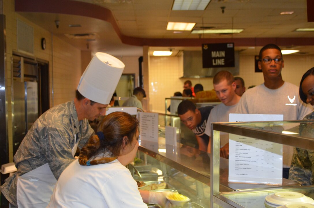 Col. Jeffrey T. Pennington, commander of the 433 Airlift Wing, Joint Base San Antonio-Lackland, Texas in the spirit of good-fellowship prepares a plate while serving lunch to over 100 members of the 433rd AW and JBSA resident technical students Dec. 9, 2012 at the Live Oak Dining Facility. (U.S. Air Force photo by Senior Master Sgt. Minnie Jones/Released)


