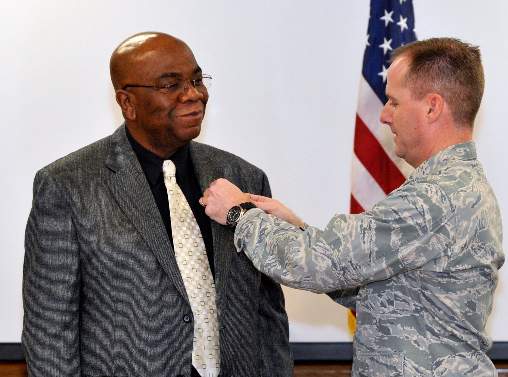 Col. John Wood, Joint Base McGuire-Dix-Lakehurst commander, honored Joseph “Joe” Dyton, 87th Civil Engineer Squadron operations manager, by presenting him with his 40-year pin Dec. 10, 2012, in the 87th CES conference room at JB MDL, N.J. Dyton began his federal career in November 1972 as a part-time student worker with the U.S. Postal Service. He also served as a Public Works Department laborer for the Naval Air Test Center and a Pipe Shop supervisor for the Lakehurst PWD. 

Dayton joined the 87th CES in 2009 where he now works in customer service. He is a self-described “people person” and said interaction with customers is what he enjoys most about his position. 

Dayton says he enjoys spending time with his 5-year-old grandson and umpiring baseball games at the high-school level and at Babe Ruth field where he worked two Babe Ruth World Series tournaments.  (U.S. Air Force photo by Wayne Russell/Released)
