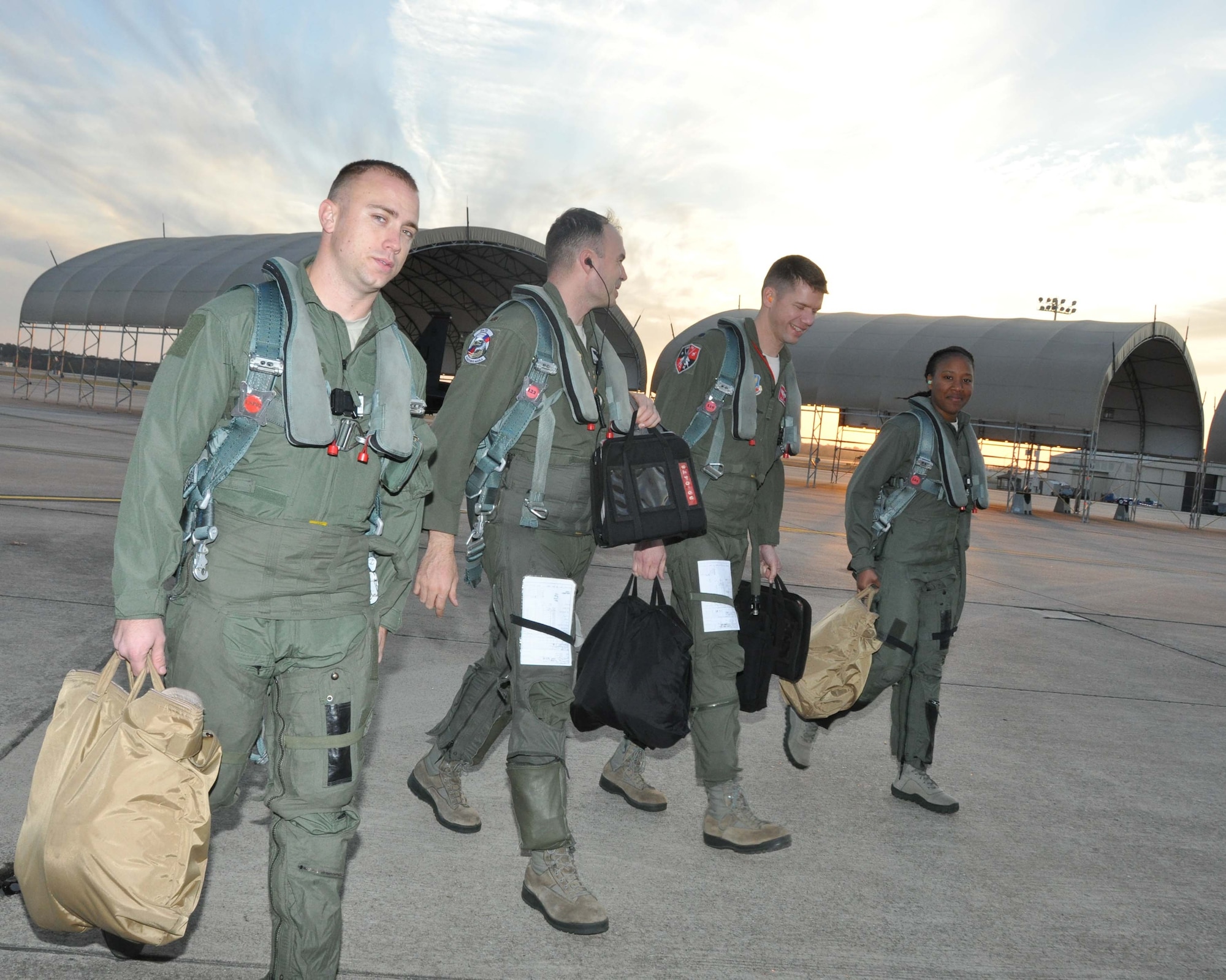 Staff Sgt. Jeffrey K. McWhorter and Senior Airman Nyeisha A. Harrington walk off of the flight line and into the sunset after completing their F-15E Strike Eagle incentive ride in November. (USAF photo by MSgt. Wendy Lopedote, 916ARW/PA)