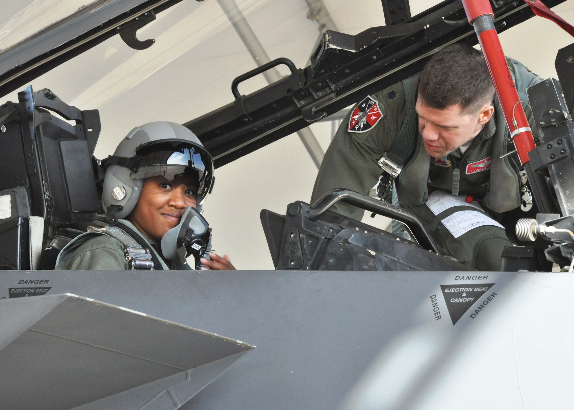 Senior Airman Nyeisha A. Harrington is excited to go after receiving pre-flight instructions from her pilot, Lt. Col. Ahren D. Heidt, 333rd Fighter Squadron. Harrington received an F-15E incentive flight in November. (USAF photo by MSgt. Wendy Lopedote, 916ARW/PA)