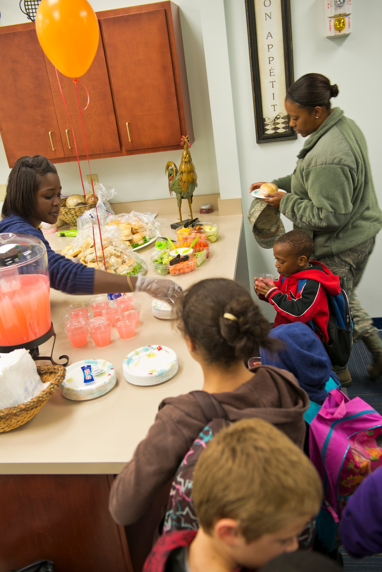 Children wait in line for food after the Moody Youth Program’s Recognition Ceremony at Moody Air Force Base Ga., 12 Dec. 2012. Drinks, sandwiches and other snacks were offered to the children after the ceremony. (U.S. Air Force photo by Senior Airman Douglas Ellis/Released)


