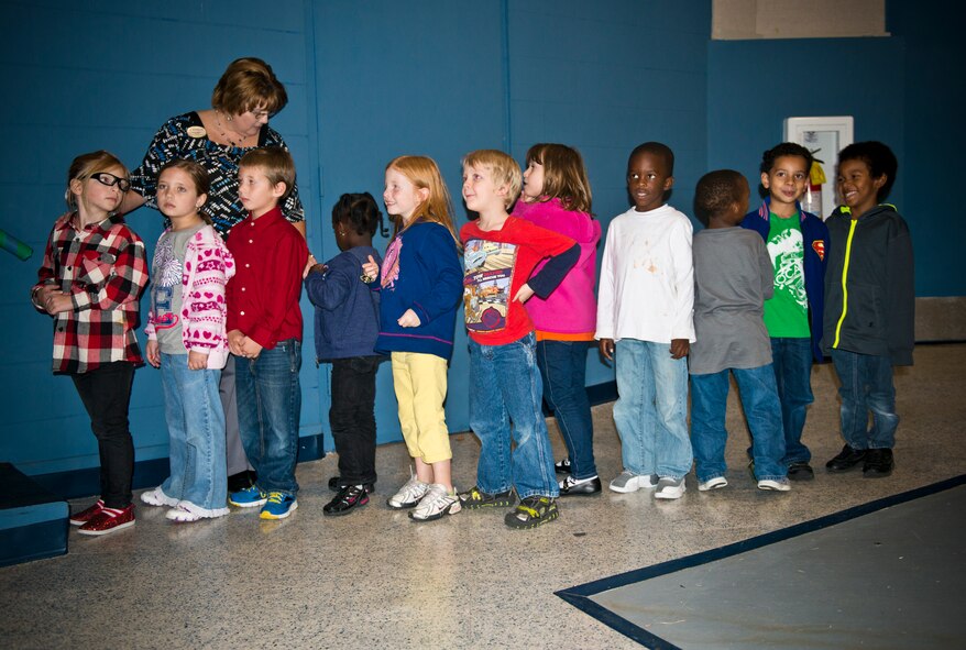Children wait in line to be recognized during the Moody Youth Program’s Recognition Ceremony at Moody Air Force Base Ga., 12 Dec. 2012. The quarterly ceremony recognized the achievements of children from the Moody Youth Program. (U.S. Air Force photo by Senior Airman Douglas Ellis/Released)   
