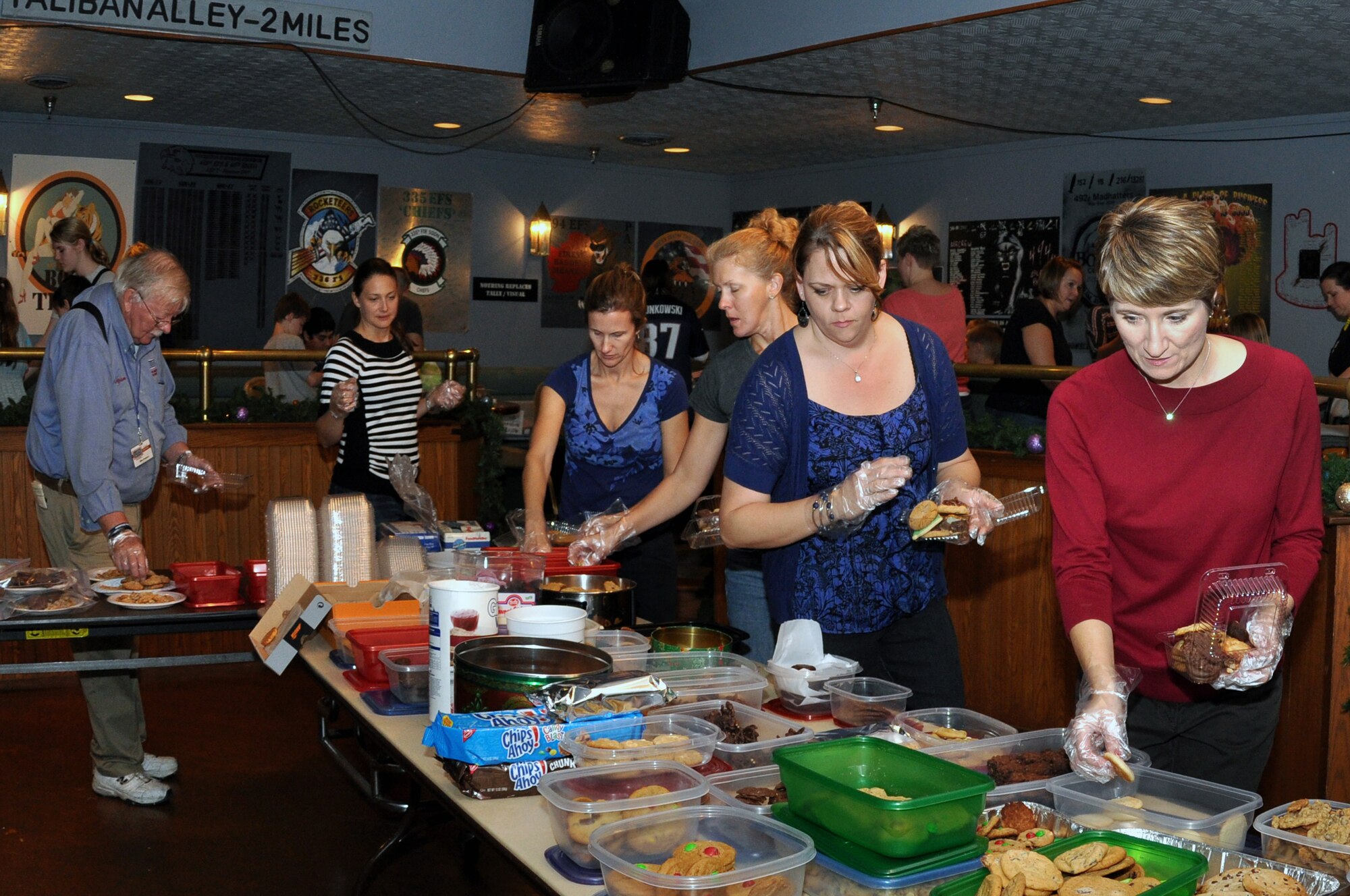 Jan Green, spouse of U.S. Air Force Col. Gabriel Green, 4th Fighter Wing vice commander, along with other military spouses, choose cookies to put into containers during a cookie drive on Seymour Johnson Air Force Base, N.C., Dec. 10, 2012. The drive was set up by the Officer and Civilian Spouses organization to spread holiday cheer to Airmen living in the dorms. (U.S. Air Force photo/Airman 1st Class Mariah Tolbert/Released)