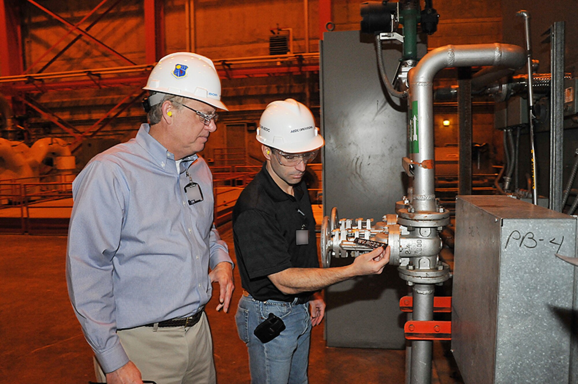 Bob Walker (left), Arnold Engineering Development Complex’s (AEDC) civil engineering branch technical director, explains AEDC’s configuration management process to a reliability engineer from Tinker AFB, Okla. (Photo provided by Bob Walker)