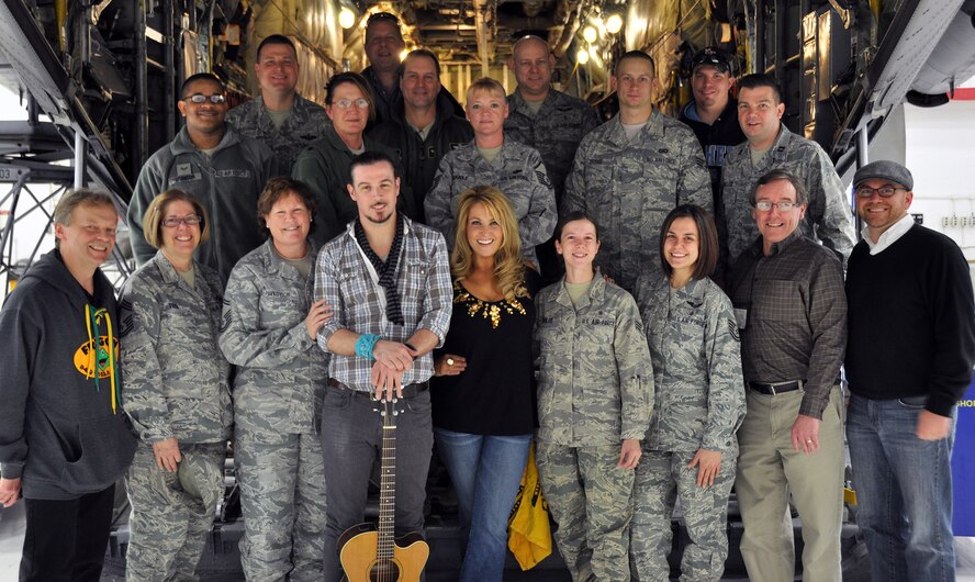 Country singer Lisa Matassa and guitarist Colin Smith, pose for a photo with members of the 911th Airlift Wing in the back of a C-130 aircraft after performing a number of songs in hanger 417 here, Dec. 12, 2012. Matassa and Smith performed on base as part of an office party that was won through a radio contest by Chief Master Sgt. Beverly G. Todd. The contest was conducted by FROGGY radio, a country music station in Pittsburgh, and FROGGY disc jockey David Hopperfield, was also present for the event.  (U.S. Air Force photo by Senior Airman Joseph E. Bridge/Released)