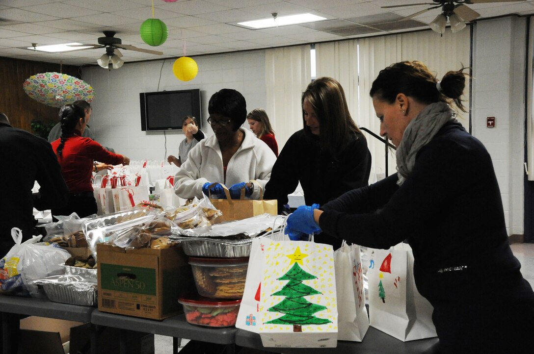 Volunteers from the OSC and ESC as well as first sergeants help package bags of cookies during the annual Sheppard "Colossal Cookie Drive," on Dec. 14. Nearly 2000 dozen cookies were collected, packaged and delivered over two days. (U.S. Air Force Photo/Kimberly Parker)