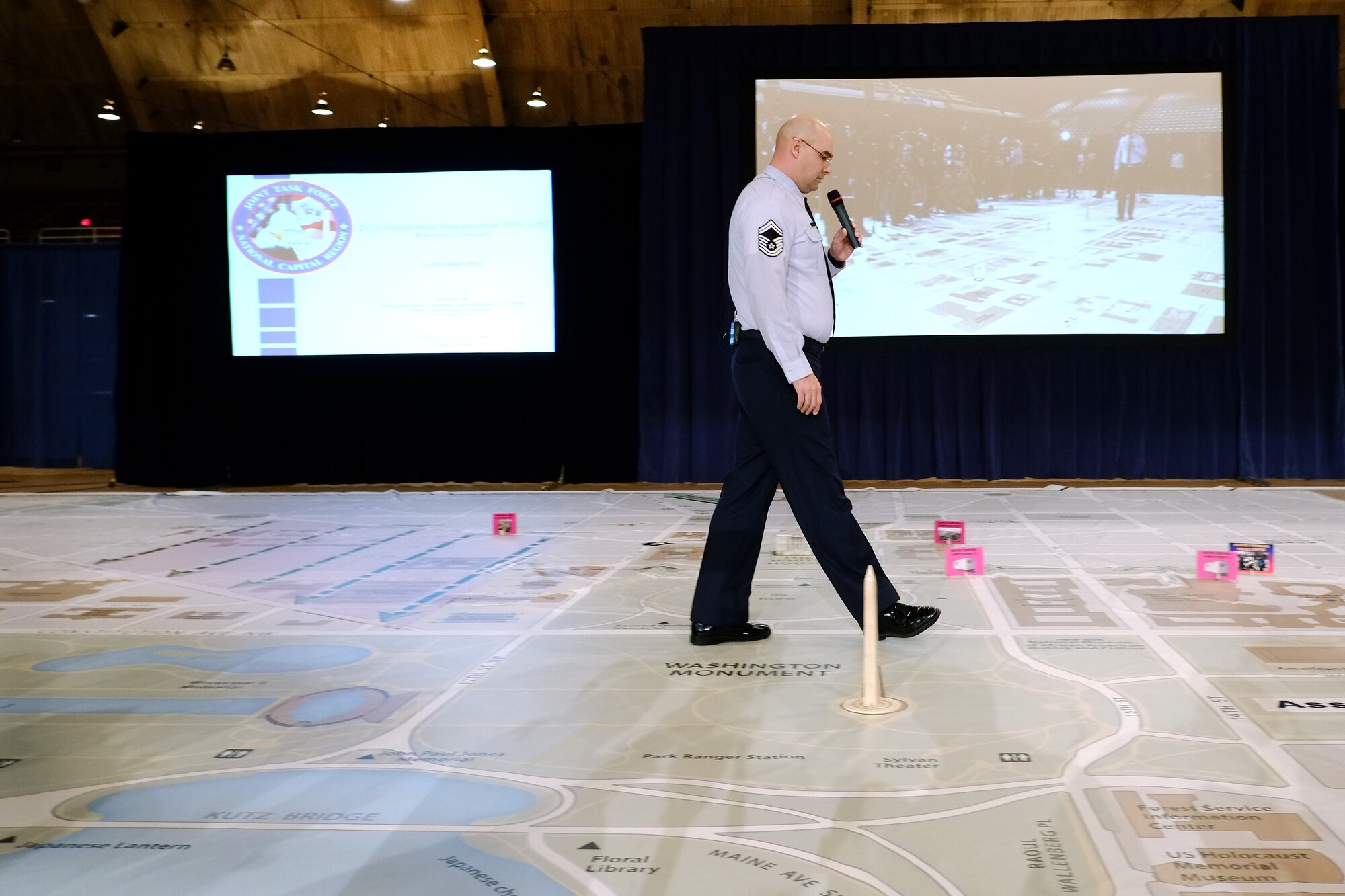 Senior Master Sgt. Scott Hinds, with the District of Columbia Air National Guard, walks along a large-scale map of Washington, D.C., while giving a briefing about aspects pertaining to the 57th Presidential Inauguration annotated on the map at the District of Columbia Armory, Wednesday, Dec. 12, 2012. The District of Columbia National Guard has participated in every presidential inauguration since 1861 and is one of the key agencies involved in planning for the upcoming inauguration. (U.S. Army photo by Sgt. 1st Class Jon Soucy)