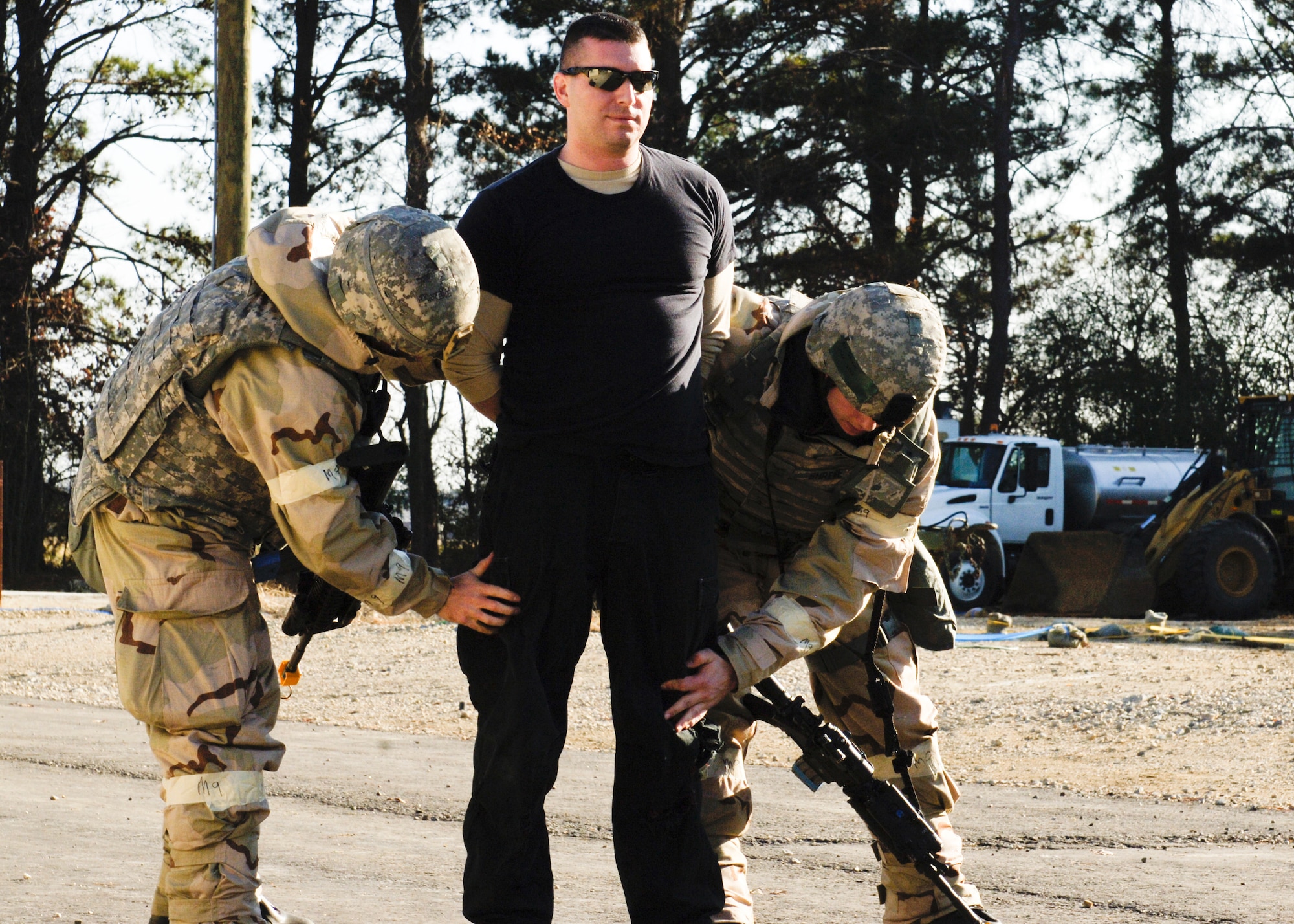 U.S Air Force Staff Sgt. Richard Russo 10th Intelligence Squadron quality assurance evaluator, poses as a simulated-armed robber arrested by the 633rd Security Forces Squadron during phase II of the combined unit exercise at Raptor Town on Langley Air Force Base, Va., Dec 13, 2012. The exercise was used to test ability of Airman to handle possible situations during deployed operations. (U.S. Air Force photo by Airman Kimberly Nagle/Released)