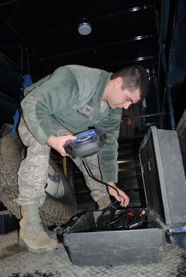 Staff Sgt. Shane McDonald, 341st Logistics Readiness Squadron mobile maintenance technician, grabs a Genesis Scan Tool before hooking up to a vehicle’s onboard diagnostics to determine a vehicle’s malfunction after an instrument cluster light turned on. (U.S. Air Force photo/Airman 1st Class Katrina Heikkinen)