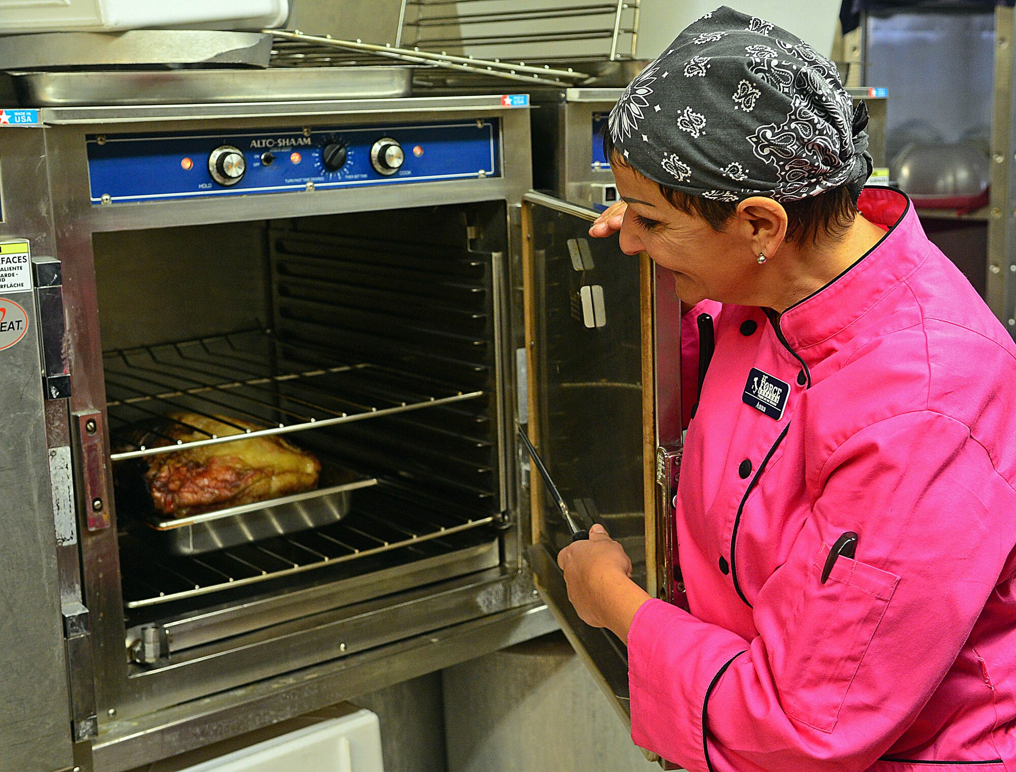 Annalisa Cariel, 31st Force Support Squadron chef, prepares a roast, Dec. 14, at the La Bella Vista Club at Aviano Air Base, Italy. The club staff is planning new programs and services for Aviano Airmen and their families for the upcoming year.  (U.S. Air Force photo by Airman 1st Class Matthew Lotz)