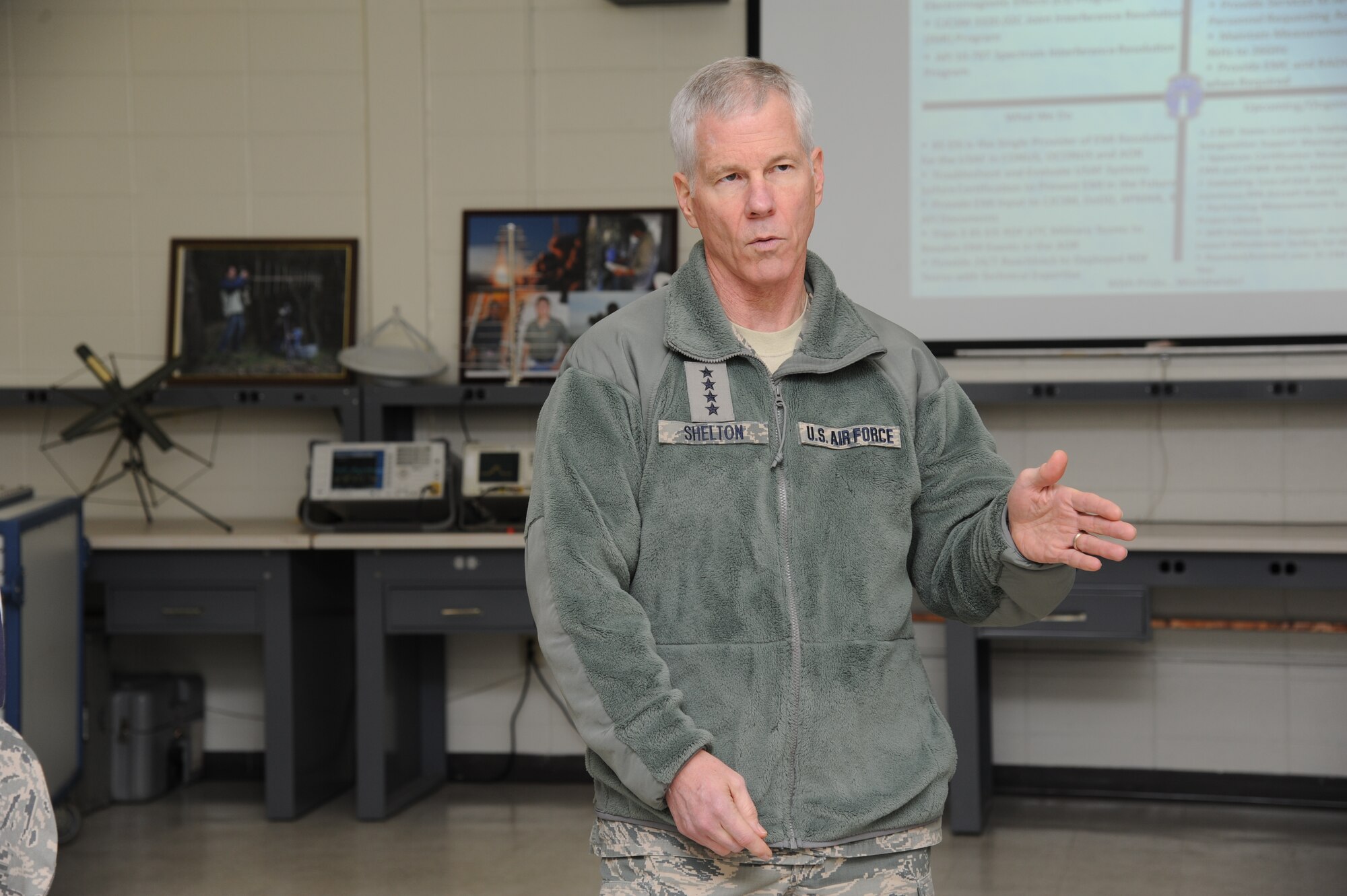 General William Shelton, Air Force Space Command commander, talks with 85th Engineering Installation Squadron staff members about their electromagnetic compatibility and interference mission and associated equipment during a tour of the squadron, Dec. 11, 2012, at Keesler Air Force Base, Miss.  General Shelton visited Keesler to see firsthand how a high deployment rate affects the 85th EIS and how the squadron contributes to the Air Force mission.  (U.S. Air Force photo by Kemberly Groue)