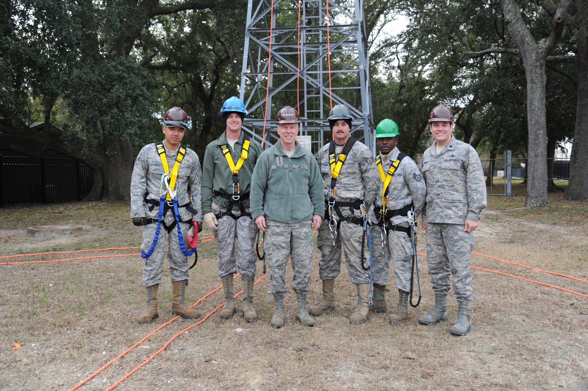 General William Shelton, Air Force Space Command commander, takes a group photo with members of the 85th Engineering Installation Squadron, Senior Airman Rathanak Ear, Staff Sgts. Aaron Bryars, Nathan Williams and Rajab Kigembe, and Lt. Col. Jeffrey Gomes, commander, following a demonstration of a standard tower rescue from 60 feet above ground, Dec. 11, 2012, at Keesler Air Force Base, Miss.  General Shelton visited Keesler to see firsthand how a high deployment rate affects the 85th EIS and how the squadron contributes to the Air Force mission. (U.S. Air Force photo by Kemberly Groue)